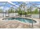 Inviting screened-in pool and spa area with brick pavers, a perfect retreat for relaxation and entertainment at 18343 Waydale Loop, Hudson, FL 34667