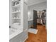 Bathroom featuring a built-in shelf, a vanity area, and a closet space filled with clothes at 204 S Trask St, Tampa, FL 33609