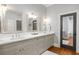 Bathroom with double vanity featuring quartz countertops and brushed nickel faucets with matching mirrors at 204 S Trask St, Tampa, FL 33609