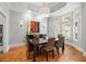 Elegant dining room with hardwood floors, a large table, and natural light from bay windows at 204 S Trask St, Tampa, FL 33609