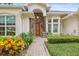 Inviting front entrance with stone accents, a wooden door, and colorful landscaping at 204 S Trask St, Tampa, FL 33609