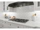 Gourmet kitchen with stainless steel appliances, a gas cooktop, and white subway tile backsplash at 204 S Trask St, Tampa, FL 33609