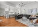 Bright living room with hardwood floors, vaulted ceilings, kitchen view, and a comfortable gray sectional sofa at 204 S Trask St, Tampa, FL 33609