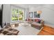 Bright and open living room featuring a large window, comfortable seating and hardwood flooring at 204 S Trask St, Tampa, FL 33609