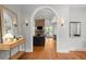 Stylish living room featuring hardwood floors, a stone fireplace, and an archway to another space at 204 S Trask St, Tampa, FL 33609