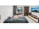 Bedroom features natural light, hardwood floors, desk, and entertainment center at 20921 Haulover Cv # 8, Lutz, FL 33558