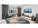 Bedroom features natural light, hardwood floors, desk, and entertainment center at 20921 Haulover Cv # 8, Lutz, FL 33558