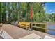 Dockside seating area with wooden benches and chairs overlooking the calm waters at 20921 Haulover Cv # 8, Lutz, FL 33558