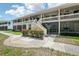 Inviting condo exterior featuring screened patios and well-maintained landscaping at 20921 Haulover Cv # 8, Lutz, FL 33558