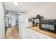 Bright kitchen featuring white cabinets and appliances, plus a butcher block countertop at 20921 Haulover Cv # 8, Lutz, FL 33558