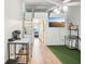Open living space featuring wood floors, tv and ladder to loft space at 20921 Haulover Cv # 8, Lutz, FL 33558