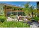 Building patio with a picnic table, green surroundings, and a covered porch overhead at 20921 Haulover Cv # 8, Lutz, FL 33558