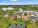 Aerial view showcases a neighborhood of homes nestled amidst lush greenery and serene lakes at 2238 Shirecrest Cove Way, Lutz, FL 33558