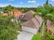 Aerial view of the property featuring a private entrance, lush greenery, and a two car garage at 2238 Shirecrest Cove Way, Lutz, FL 33558