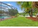 Beautiful backyard with lush lawn, mature trees, and scenic view of the peaceful lake at 2238 Shirecrest Cove Way, Lutz, FL 33558