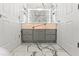 Bright bathroom featuring marble tile and a vanity with modern fixtures at 2238 Shirecrest Cove Way, Lutz, FL 33558