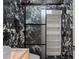 Chic bathroom features marble walls and floors, frosted glass barn door to storage shelves at 2238 Shirecrest Cove Way, Lutz, FL 33558