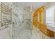 Marble bathroom with a glass shower and custom cabinets at 2238 Shirecrest Cove Way, Lutz, FL 33558