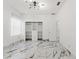 Well-lit bedroom featuring custom built-in shelving and marble flooring at 2238 Shirecrest Cove Way, Lutz, FL 33558