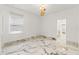 Bright bedroom with marble floors, modern lighting, and large window at 2238 Shirecrest Cove Way, Lutz, FL 33558