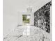 Bedroom with marble floors, modern light fixture, and access to screened-in pool and water view at 2238 Shirecrest Cove Way, Lutz, FL 33558