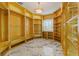 Spacious walk-in closet with custom built-in shelving and drawers at 2238 Shirecrest Cove Way, Lutz, FL 33558