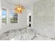 Bright dining area featuring a brick accent wall and colorful light fixture at 2238 Shirecrest Cove Way, Lutz, FL 33558
