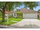 Charming single-story home boasts lush landscaping, a two car garage and mature trees at 2238 Shirecrest Cove Way, Lutz, FL 33558