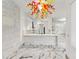 Open floorplan with a large kitchen island featuring stone accents, marble countertops, and colorful chandelier at 2238 Shirecrest Cove Way, Lutz, FL 33558