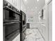 Bright, spacious kitchen with marble floors, stainless appliances, white cabinetry and a view from the sink at 2238 Shirecrest Cove Way, Lutz, FL 33558