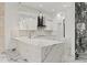 Modern kitchen with white cabinets, marble countertops, and stylish pendant lighting at 2238 Shirecrest Cove Way, Lutz, FL 33558