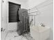 Modern laundry room features stacked washer/dryer, utility sink, and marble tile flooring at 2238 Shirecrest Cove Way, Lutz, FL 33558