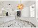Open floorplan with a view of the kitchen, and colorful chandelier over an accent wall at 2238 Shirecrest Cove Way, Lutz, FL 33558
