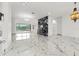 Open concept living room featuring marble floors, accent wall and view of the pool at 2238 Shirecrest Cove Way, Lutz, FL 33558