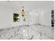 Spacious living room with marble floors, contemporary lighting, and bright windows at 2238 Shirecrest Cove Way, Lutz, FL 33558