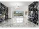 Spacious living room with elegant marble floors, modern lighting, a decorative fireplace, and pool views at 2238 Shirecrest Cove Way, Lutz, FL 33558