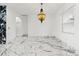 Bright and airy living room with elegant marble floors, modern lighting, and a decorative fireplace at 2238 Shirecrest Cove Way, Lutz, FL 33558