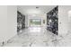 Spacious living room features marble floors, accent wall, and backyard pool view at 2238 Shirecrest Cove Way, Lutz, FL 33558