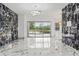 Elegant living room with marble floors, modern lighting, and pool view at 2238 Shirecrest Cove Way, Lutz, FL 33558