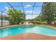 Screened-in pool with a stunning lake view at 2238 Shirecrest Cove Way, Lutz, FL 33558