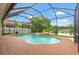 Screened-in pool area with water feature overlooking a scenic lake at 2238 Shirecrest Cove Way, Lutz, FL 33558