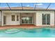Inviting pool and patio with a covered area and sliding glass doors at 2238 Shirecrest Cove Way, Lutz, FL 33558