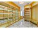 Large walk-in closet with shelving, drawers, a view of the bathroom and marble floors at 2238 Shirecrest Cove Way, Lutz, FL 33558