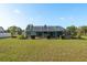 Well-manicured backyard with a screened-in pool enclosure, perfect for outdoor enjoyment at 22755 Cypress Trail Dr, Lutz, FL 33549