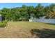 Expansive backyard features a well-maintained lawn and a privacy fence at 22755 Cypress Trail Dr, Lutz, FL 33549