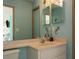 Bathroom featuring light blue walls, a vanity with an oval sink, and decorative wall art at 22755 Cypress Trail Dr, Lutz, FL 33549