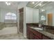 Bright bathroom features a soaking tub under an arched window and a separate glass-enclosed shower at 22755 Cypress Trail Dr, Lutz, FL 33549