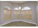 Cozy breakfast nook with arched windows, stylish lighting, and neutral wall color, perfect for morning coffee at 22755 Cypress Trail Dr, Lutz, FL 33549