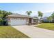 Charming single Gathering home featuring a well-maintained lawn, mature landscaping, and neutral color palette at 22755 Cypress Trail Dr, Lutz, FL 33549