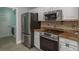 Kitchen featuring stainless steel appliances, granite countertops, tiled backsplash, and modern cabinetry at 22755 Cypress Trail Dr, Lutz, FL 33549